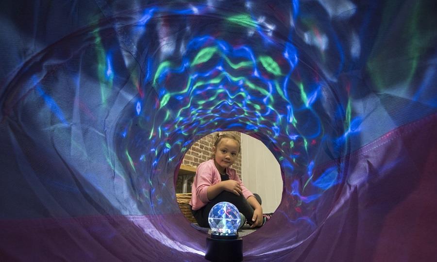 Child looking through tunnel with sensory light